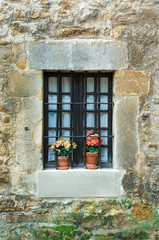 stone wall and window with bars