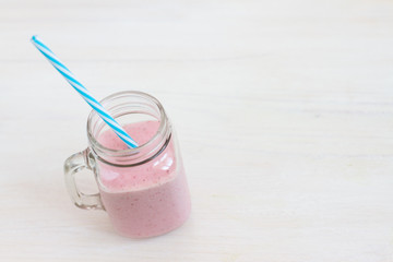 cold milkshake smoothie in glass jar  cup on white backogrund. free space