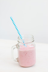 glass of milkshake on white background