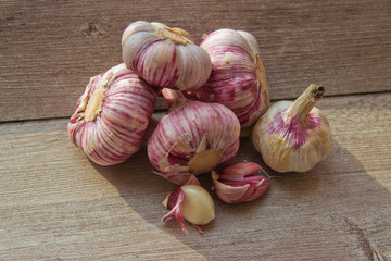 garlic heads on a wooden background in natural light