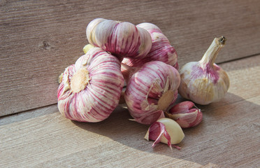 garlic heads on a wooden background in natural light