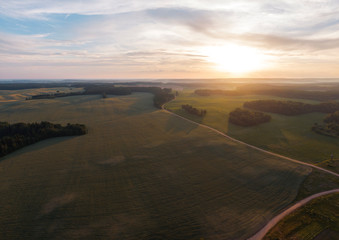 Fields and forests at sunset.
