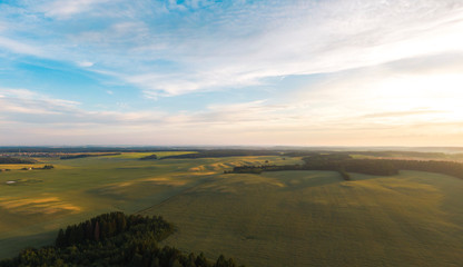 Fields and forests at sunset.