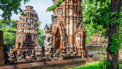Only intact ancient Buddha statue among the destroyed statues in Ayutthaya historical park, Thailand. - 275901262