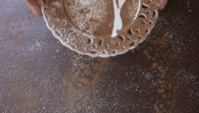 Top view of woman hands laying a dessert empty plate on dark background. Yummy chocolate  concept