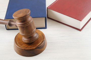 Judge's gavel and blue and red legal books