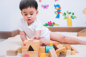 Child boy building playing toy blocks wood