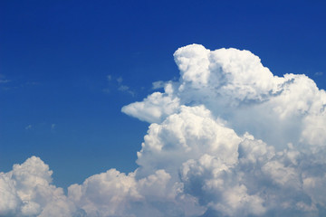 Landscape of cumulonimbus clouds floating in sunny summer sky