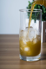 filling an empty ice cold glass with sugar cane