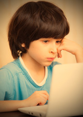 child looking at a computer monitor
