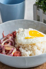 delicious morning breakfast corned beef with egg on top of rice
