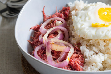 delicious morning breakfast corned beef with egg on top of rice
