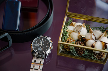 Men's perfume and wrist watches in a box close-up. Men's accessories