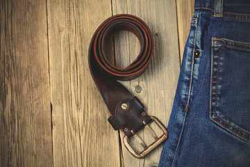 Obraz premium Vintage blue jeans and old leather belt