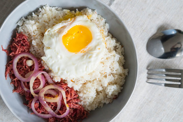 delicious morning breakfast corned beef with egg on top of rice