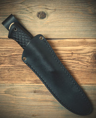 hunting knife in a leather scabbard