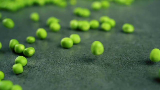 Green fresh pea falling in slow motion. Close up food background video.