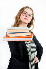 Young woman in glasses holding a few books on white