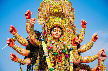 Golden and colorful statue of ten handed goddess Durga being worshiped with flower on the occasion...