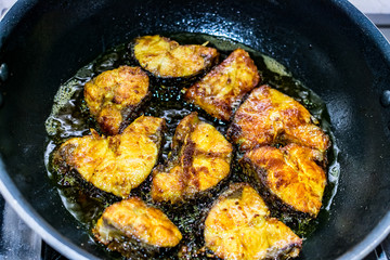Deep frying cut fish  in low flame looking delicious.