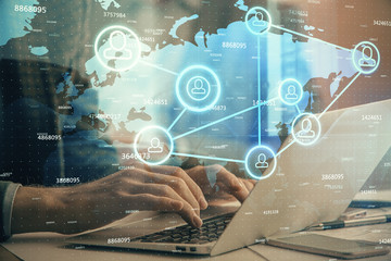 Social network theme hologram with businessman working on computer on background. Concept of world wide web. Double exposure.