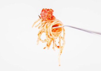 Spaghetti bolognese on a fork on a white background	