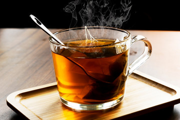 Hot herbal tea in dark background