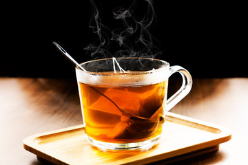 Hot herbal tea in dark background