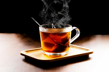 Hot herbal tea in dark background