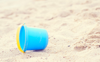 Plastic children's toys in the sand. Concept of beach recreation for children.