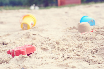 Fototapeta na wymiar Plastic children's toys in the sand. Concept of beach recreation for children.