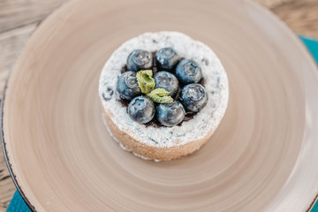 cake with blueberry and sand dough on a yellow plate with mint