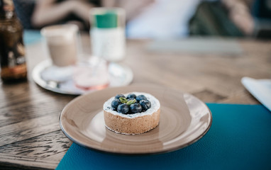 cake with blueberry and sand dough on a yellow plate with mint