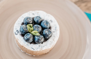 cake with blueberry and sand dough on a yellow plate with mint