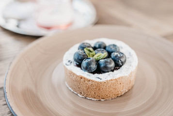 cake with blueberry and sand dough on a yellow plate with mint