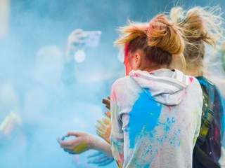 Festival of colors. People covered with colored powder. Color holi festival. Celebrants dancing during the color Holi Festival