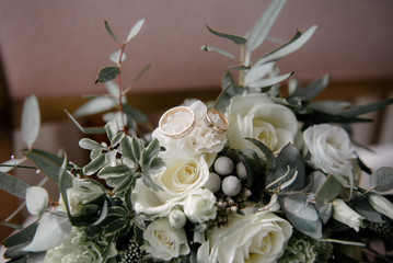 Wedding rings lie on a flower close up