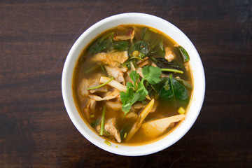 Hot and spicy pork bone with tamarind and Thai herbs soup on bowl