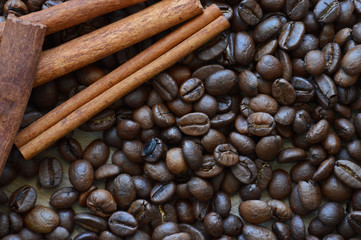 Cinnamon sticks on the background of coffee beans