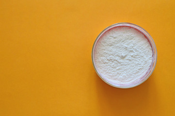 A plate of flour on an orange background