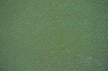 Texture of patterned green decorative plaster on the wall