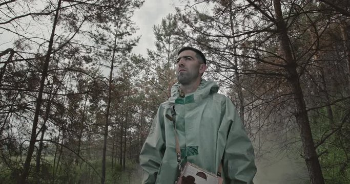 Man in hazmat suit in radioactive forest