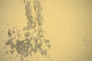 Texture of wet, peeling plaster on the wall
