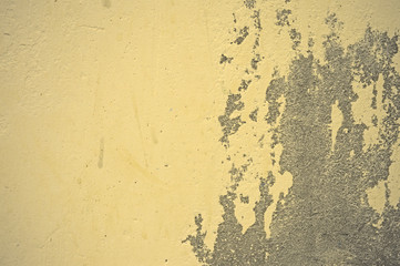 Texture of wet, peeling plaster on the wall