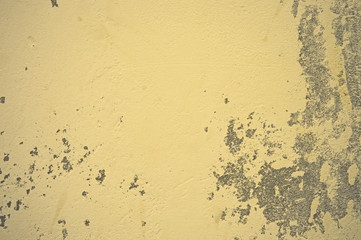 Texture of wet, peeling plaster on the wall