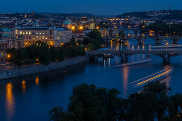 View of Prague and Vltava river at night after sunset. Beautiful city landscape