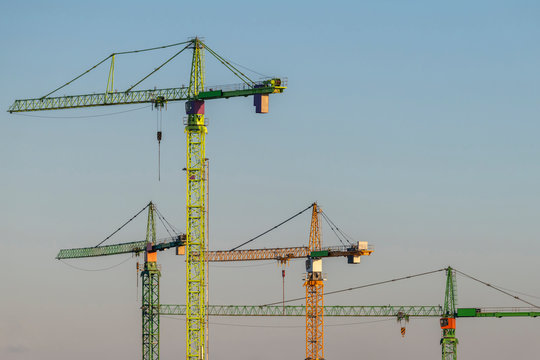 Colorful tower cranes in the evening light.