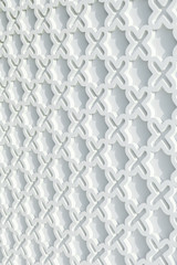 vertical of  repeating pattern of the wall is a white cross geometric style.