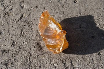 yellow resin stone on a grey textured surface