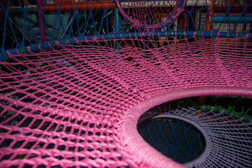 pink macro thread webs on a playground